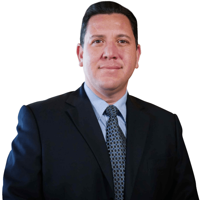 A man in a suit and tie standing up against a green background.