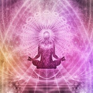 A person sitting in the lotus position with their hands in the air.