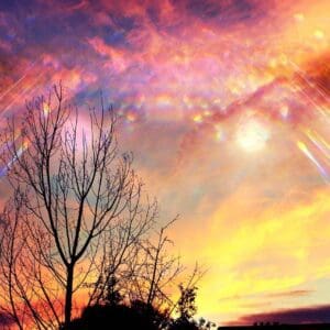 A colorful sky with sun shining through the clouds.
